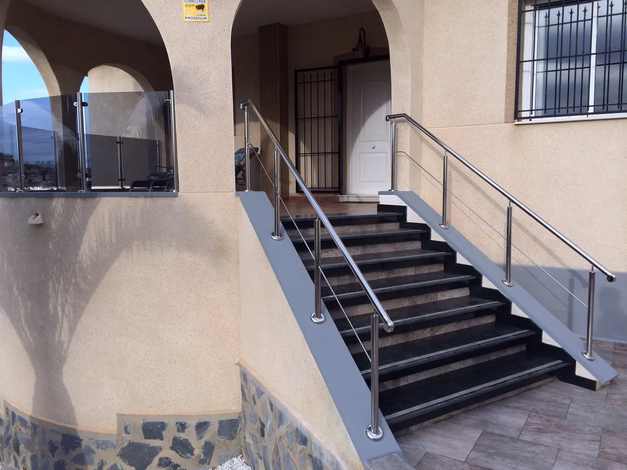 Granite staircase with stainless steel handrail built by URPE Spain